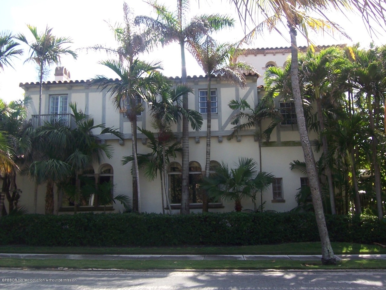 79 Middle Road Palm Beach, FL 33480 - Photo 9 of 24 a view of a white house with a small yard and palm trees