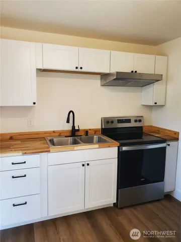 a kitchen with stainless steel appliances granite countertop a sink and a stove
