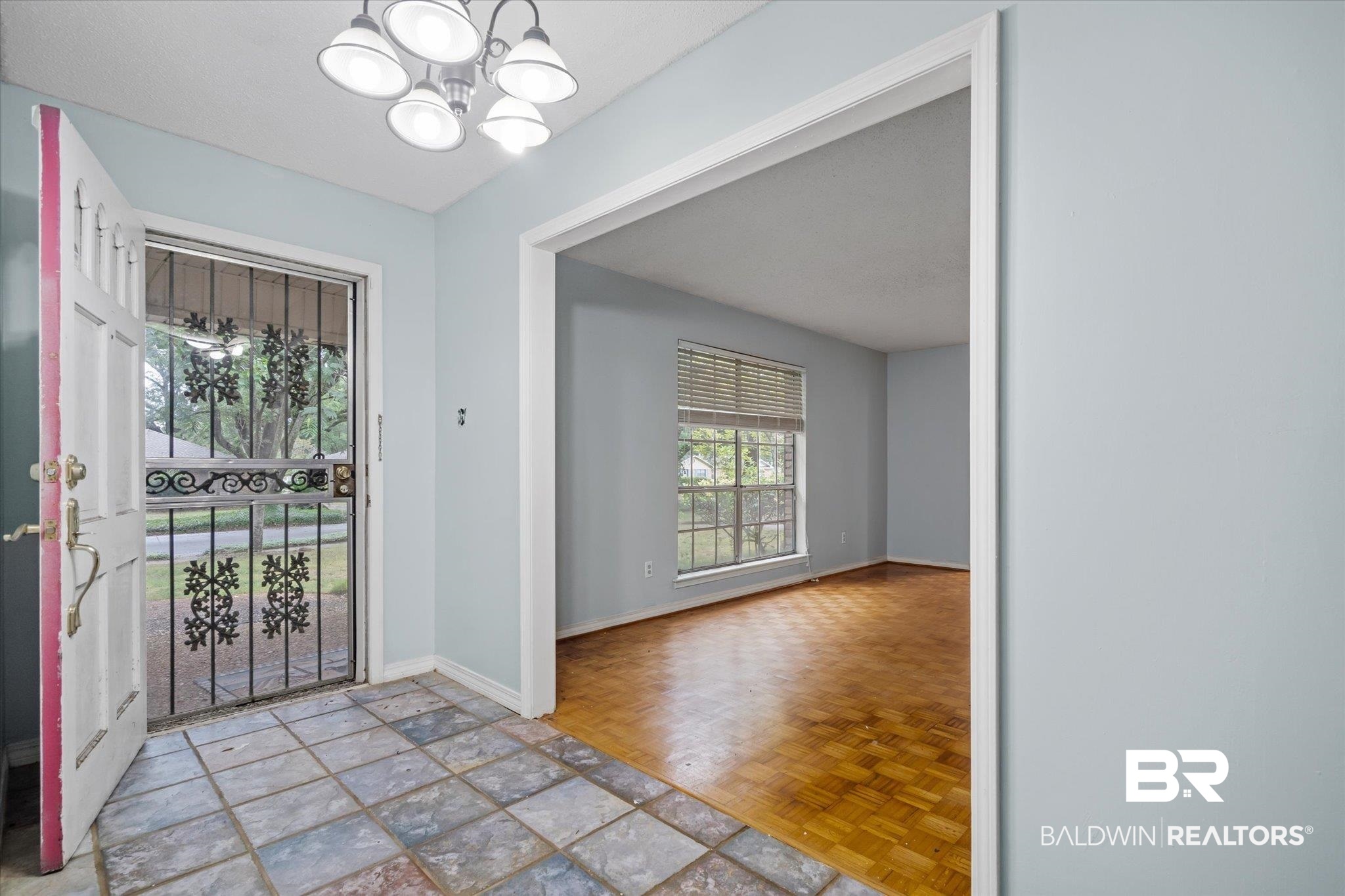 6657 Hounds Run South Mobile, AL 36608 - Photo 2 of 20 Doorway to outside with an inviting chandelier and light parquet flooring