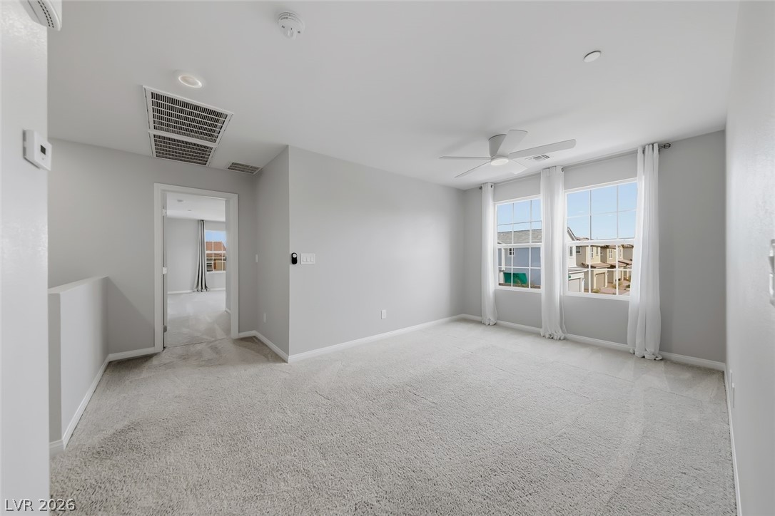 3564 Credere Lane Henderson, NV 89074 - Photo 16 of 40 Unfurnished room with light carpet and ceiling fan