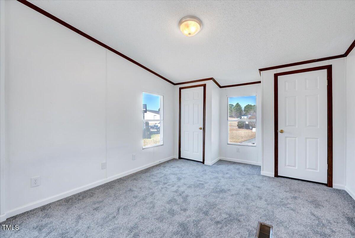 56 Jefferson Lane Cameron, NC 28326 - Photo 10 of 38 an empty room with windows and mirror