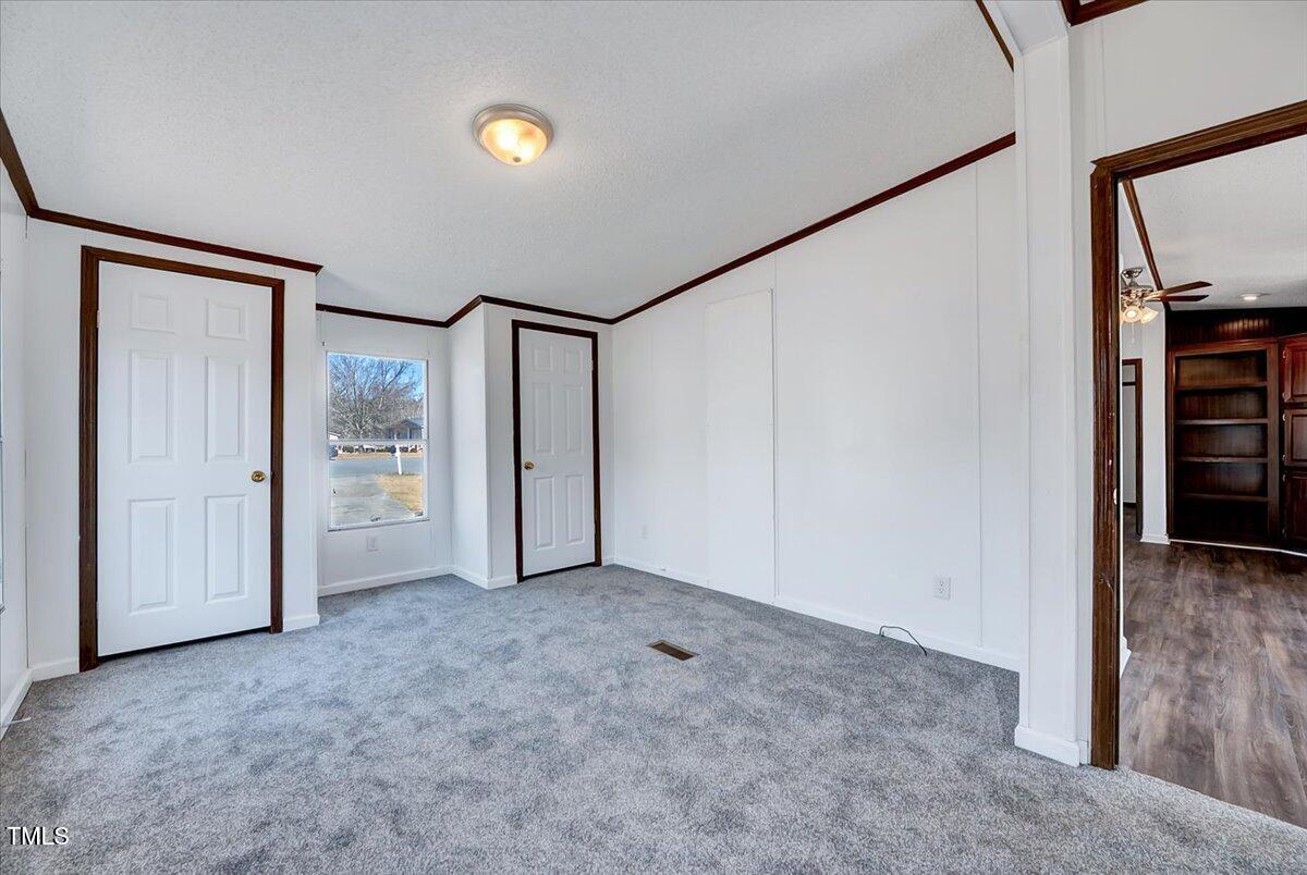 56 Jefferson Lane Cameron, NC 28326 - Photo 11 of 38 an empty room with closet and mirror