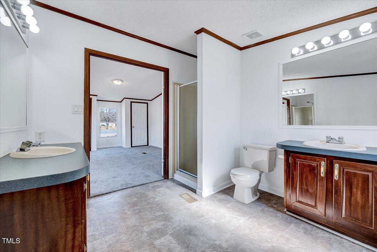 56 Jefferson Lane Cameron, NC 28326 - Photo 15 of 38 a spacious bathroom with a sink and a mirror