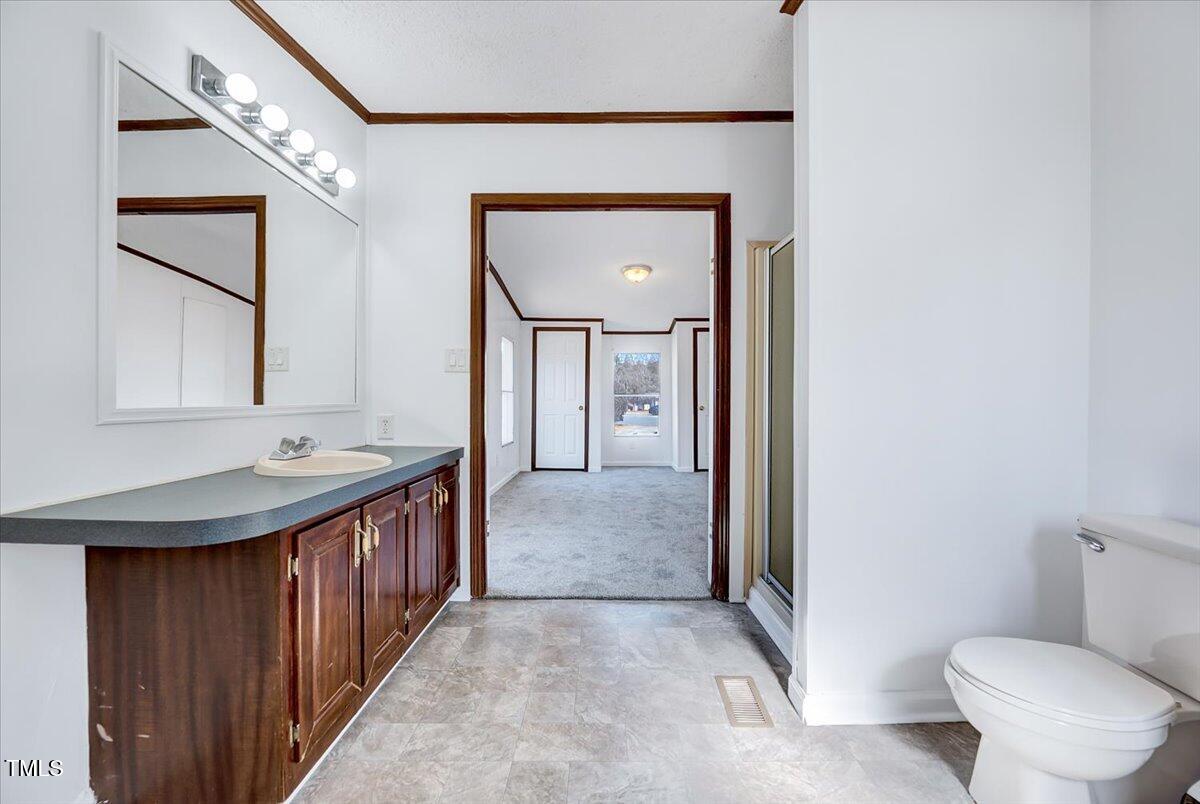 56 Jefferson Lane Cameron, NC 28326 - Photo 16 of 38 a bathroom with a toilet a sink and mirror