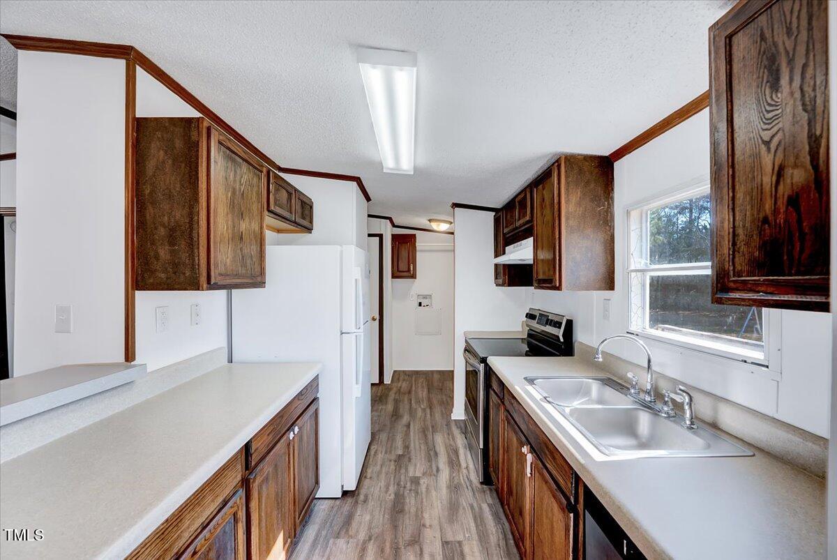 56 Jefferson Lane Cameron, NC 28326 - Photo 18 of 38 a kitchen with a sink stove and a refrigerator