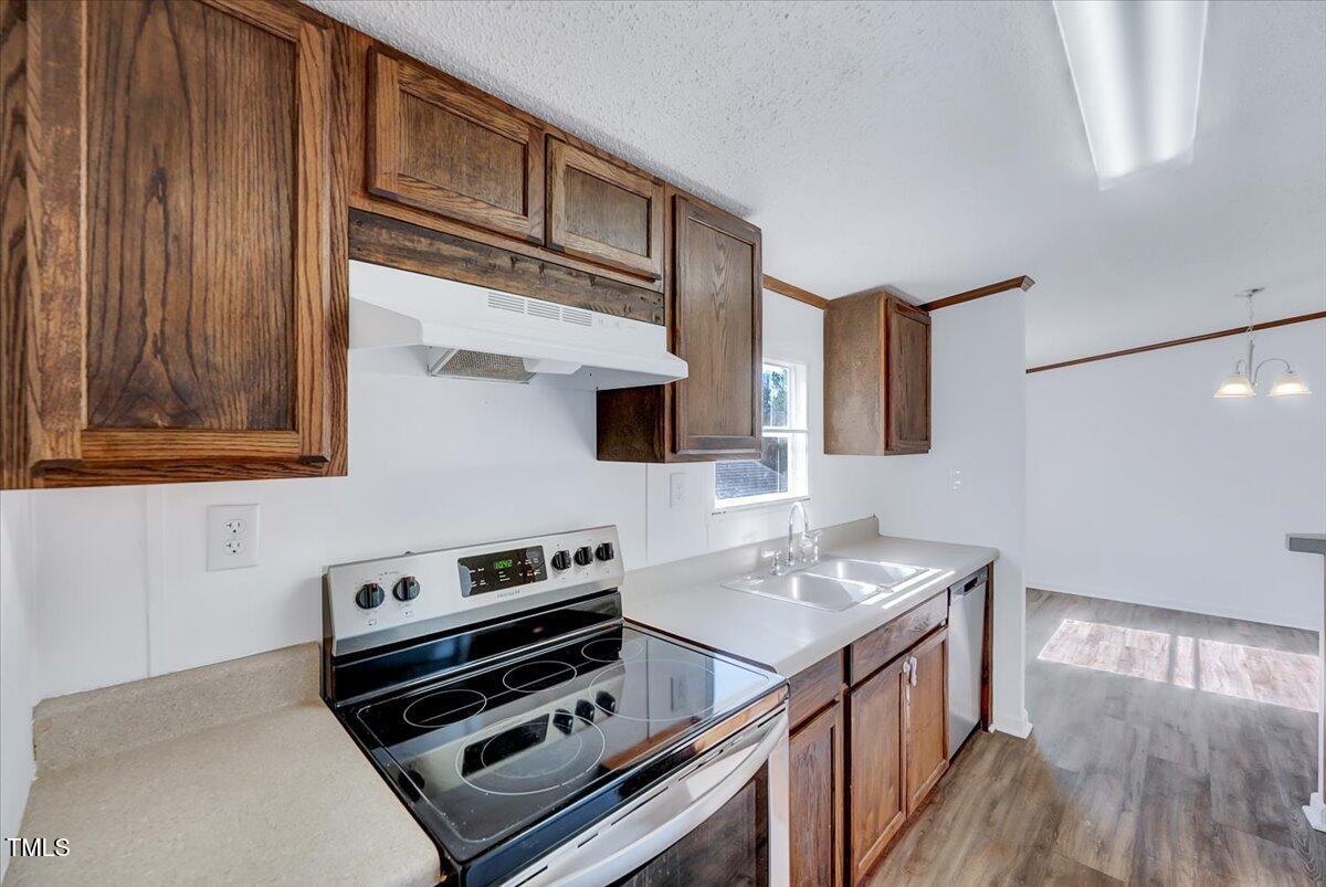 56 Jefferson Lane Cameron, NC 28326 - Photo 20 of 38 a kitchen with wooden cabinets and a stove top oven