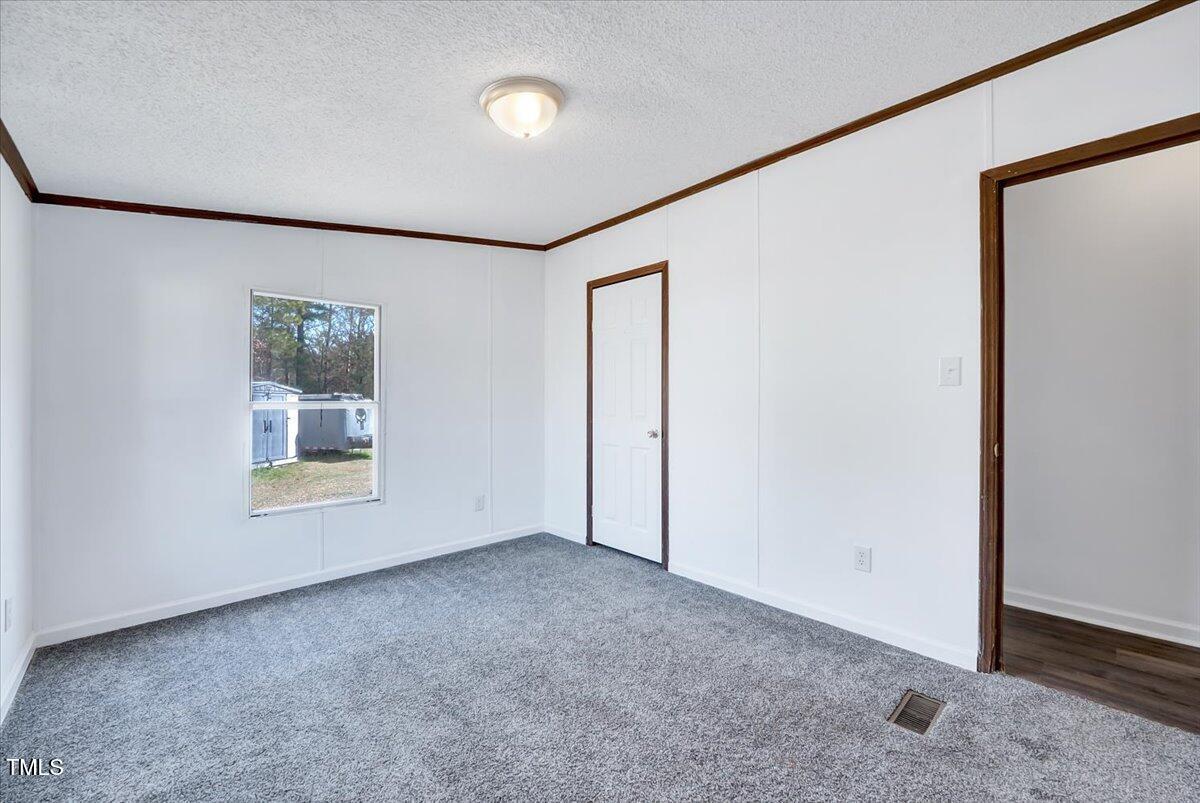 56 Jefferson Lane Cameron, NC 28326 - Photo 26 of 38 an empty room with windows and closet