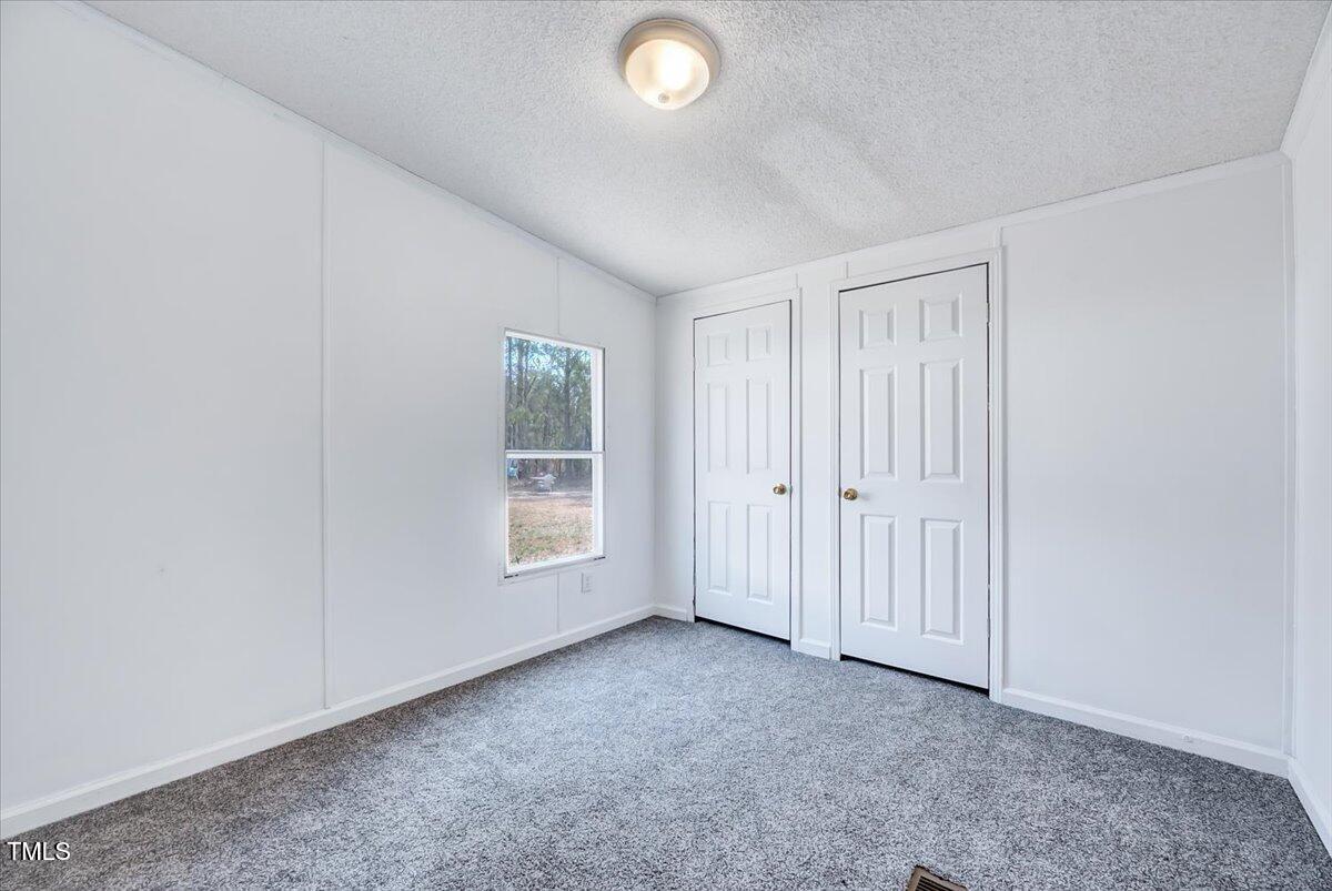 56 Jefferson Lane Cameron, NC 28326 - Photo 27 of 38 an empty room with windows