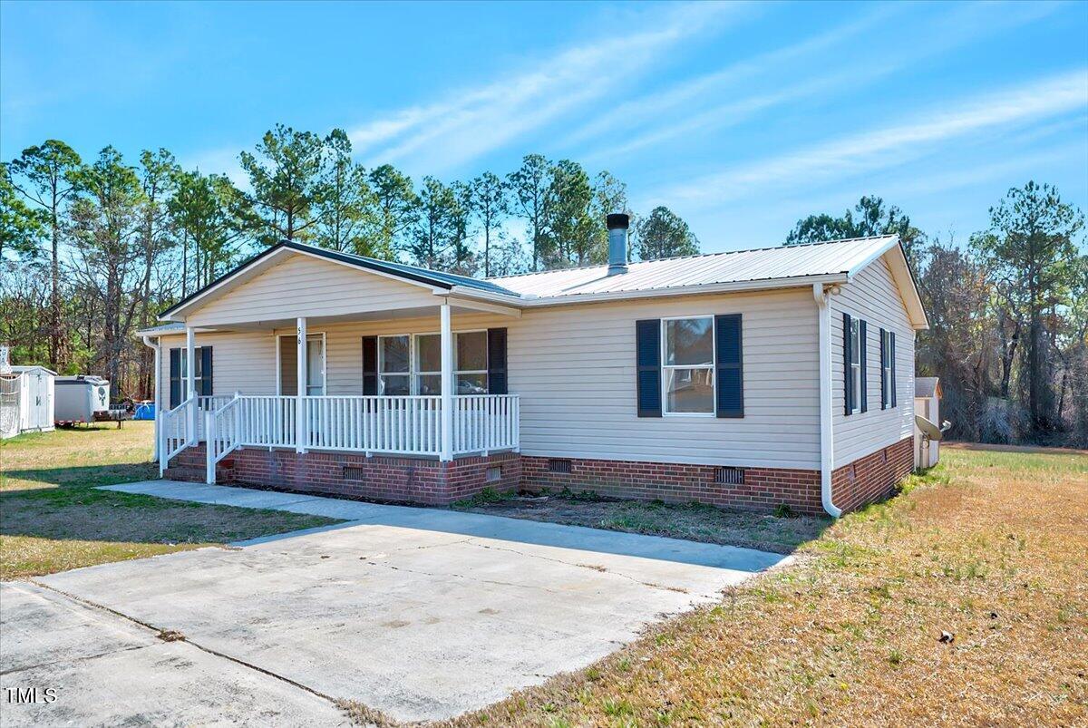 56 Jefferson Lane Cameron, NC 28326 - Photo 3 of 38 a front view of a house with a yard