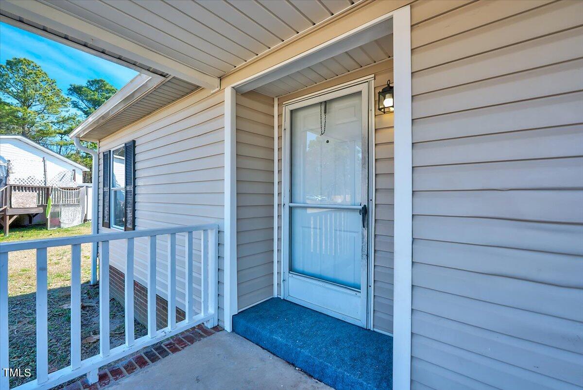 56 Jefferson Lane Cameron, NC 28326 - Photo 4 of 38 a view of a porch with wooden floor