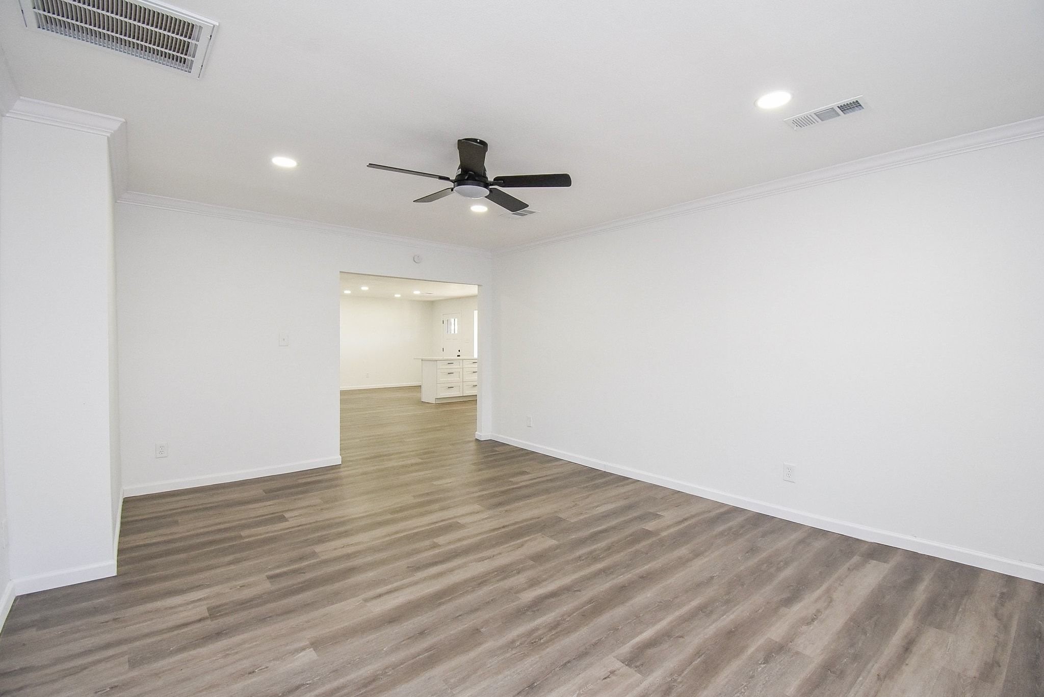 514 Peach Spring Drive Houston, TX 77037 - Photo 11 of 27 a view of empty room with wooden floor and ceiling fan