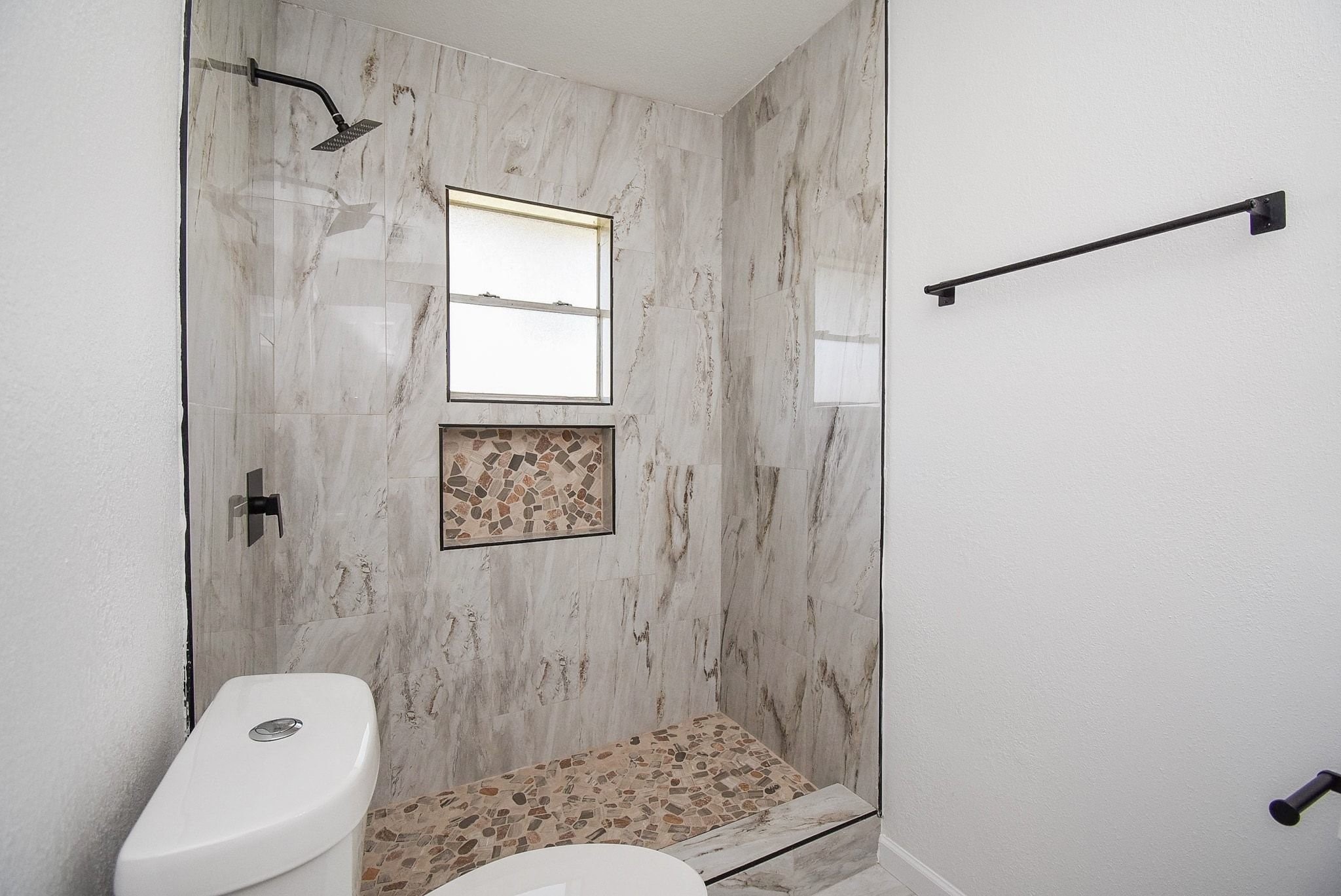 514 Peach Spring Drive Houston, TX 77037 - Photo 16 of 27 a bathroom with a shower and a toilet