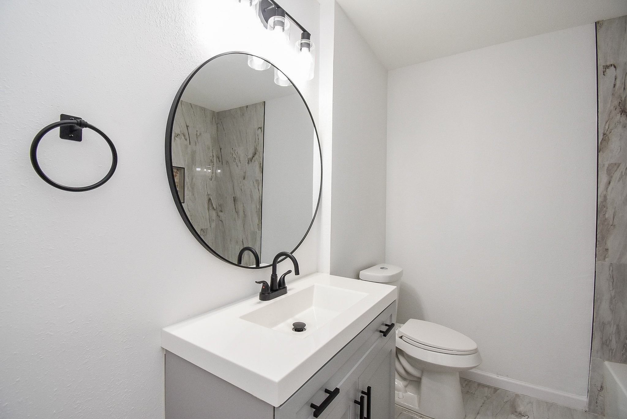 514 Peach Spring Drive Houston, TX 77037 - Photo 18 of 27 a bathroom with a toilet a sink and a mirror