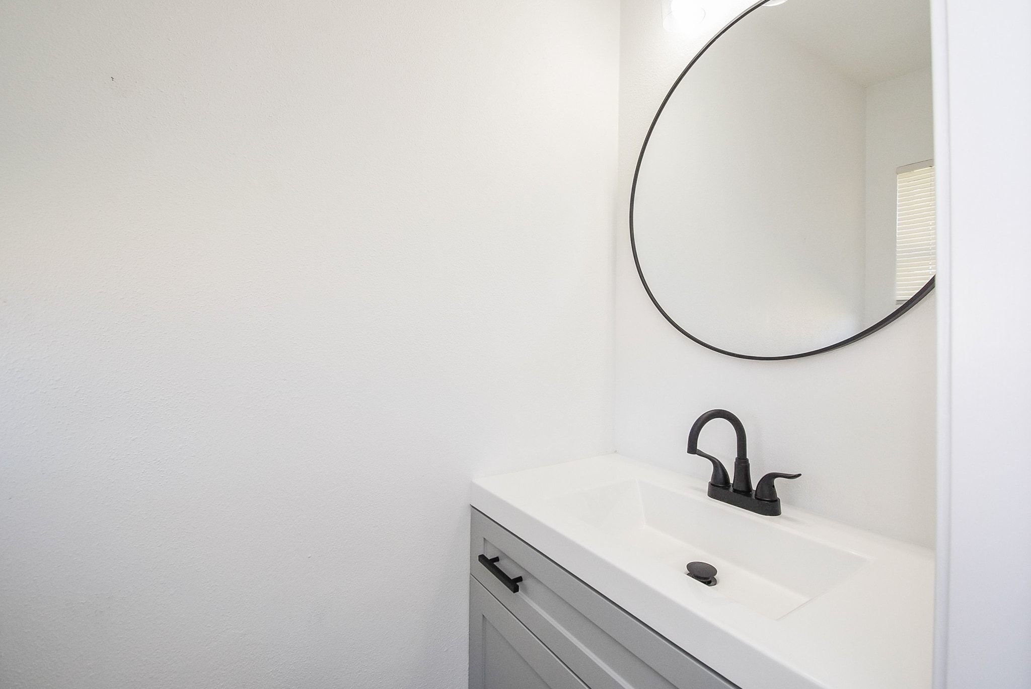 514 Peach Spring Drive Houston, TX 77037 - Photo 23 of 27 a bathroom with a sink and a mirror