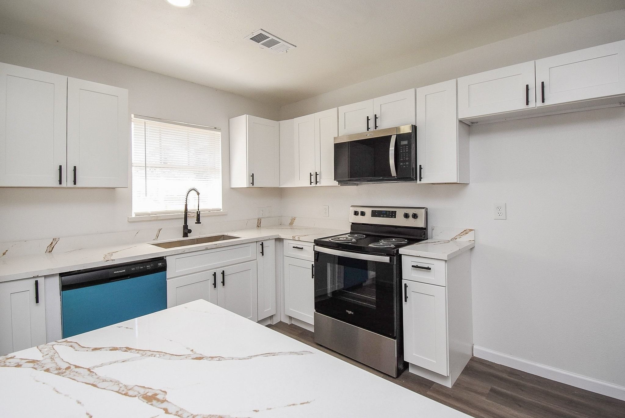 514 Peach Spring Drive Houston, TX 77037 - Photo 7 of 27 a kitchen with cabinets stainless steel appliances and a sink