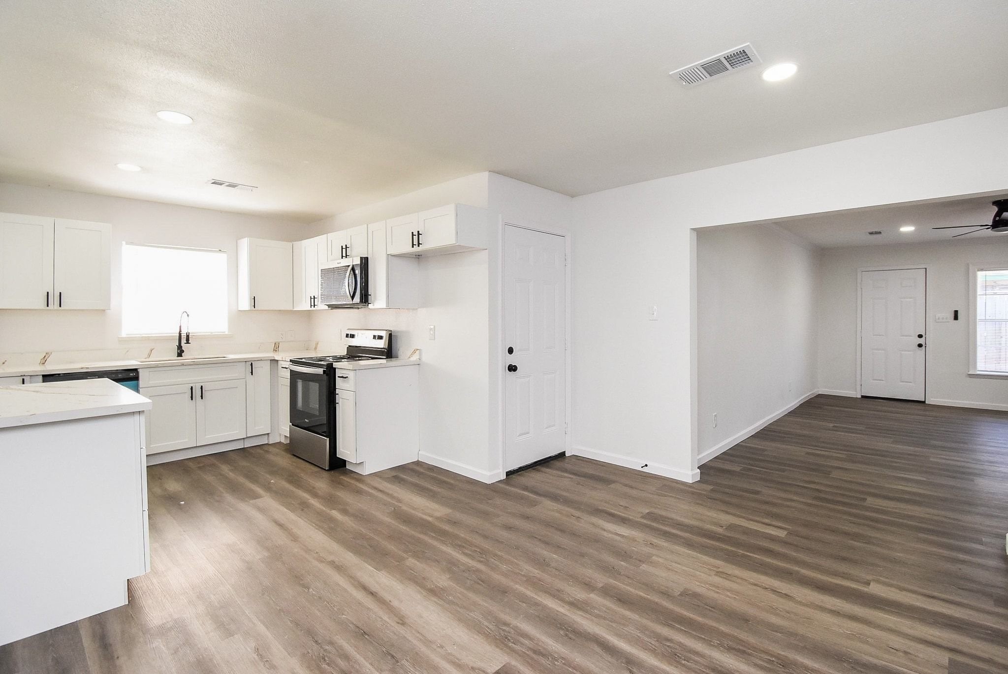 514 Peach Spring Drive Houston, TX 77037 - Photo 27 of 27 a kitchen with granite countertop a sink cabinets and wooden floor