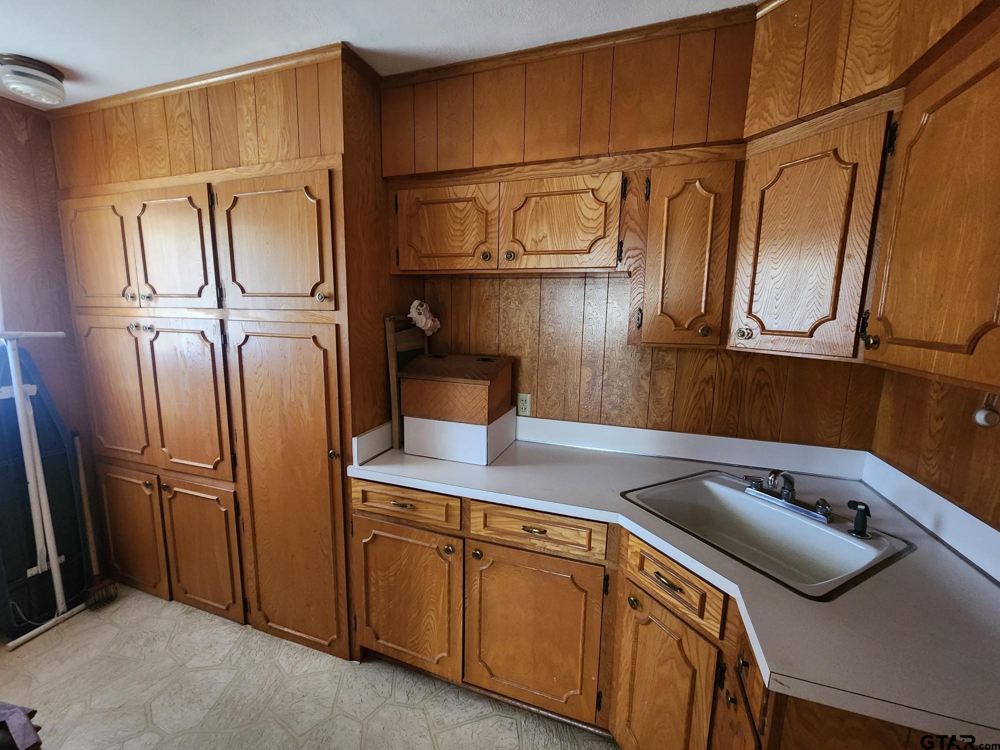 512 E Lane Quitman, TX 75783 - Photo 17 of 32 a kitchen with stainless steel appliances granite countertop a sink a refrigerator and cabinets