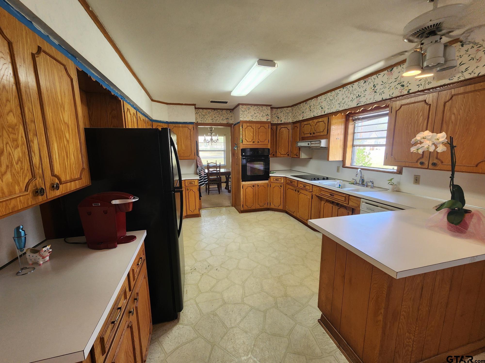 512 E Lane Quitman, TX 75783 - Photo 20 of 32 a kitchen with a cabinets a sink and a stove top oven