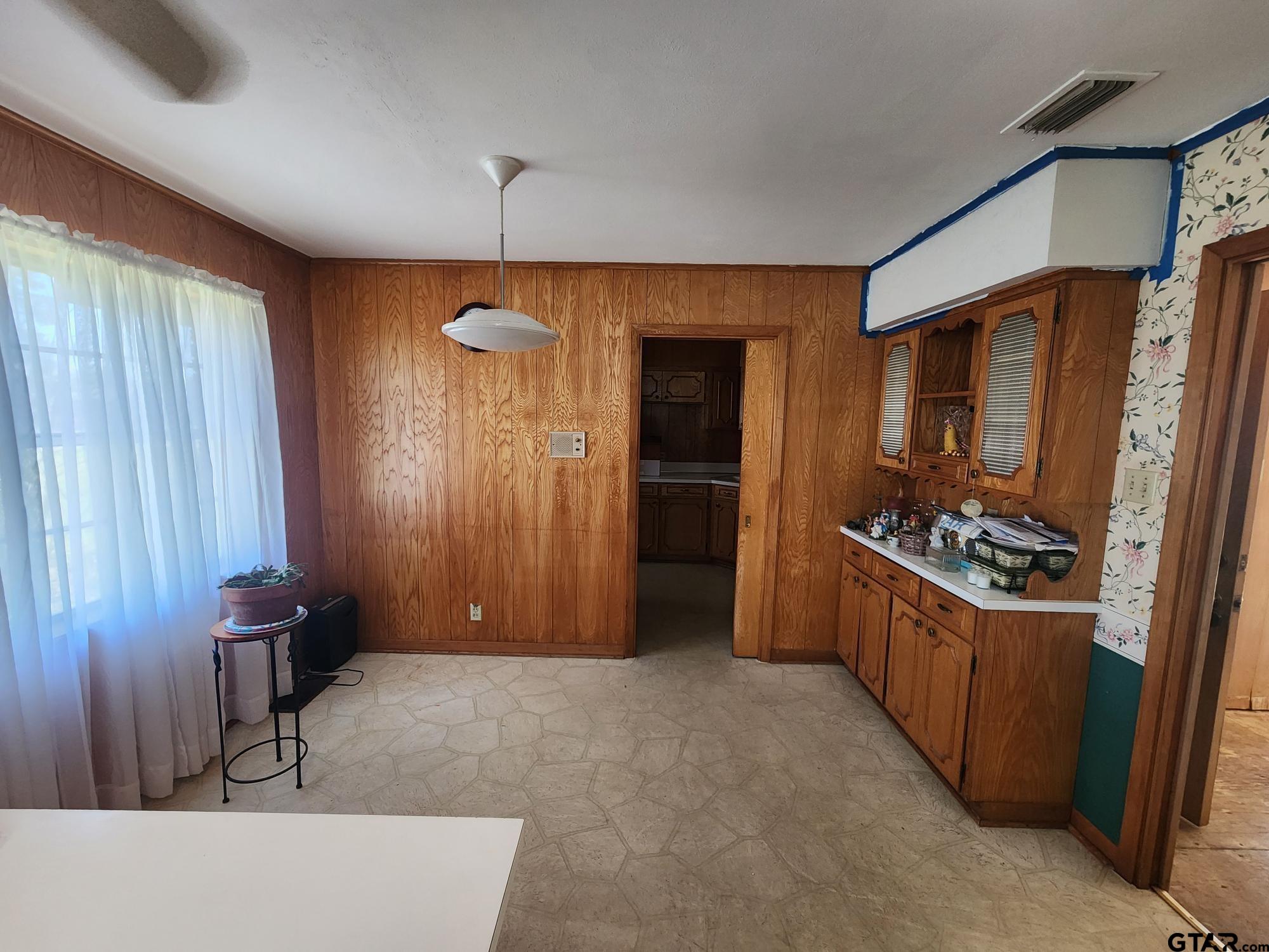 512 E Lane Quitman, TX 75783 - Photo 22 of 32 a kitchen with refrigerator and cabinets