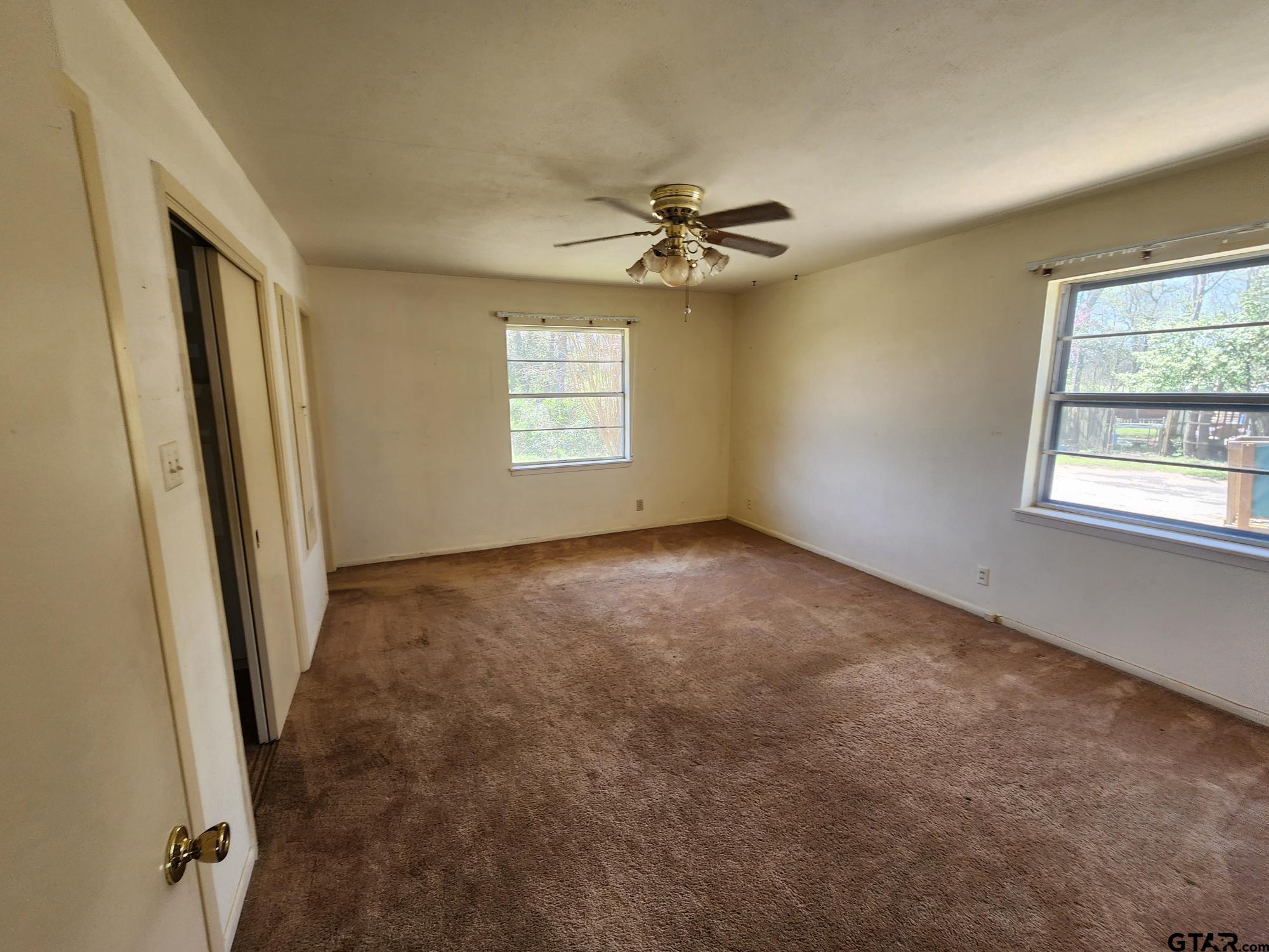 512 E Lane Quitman, TX 75783 - Photo 25 of 32 a view of room with a ceiling fan and window