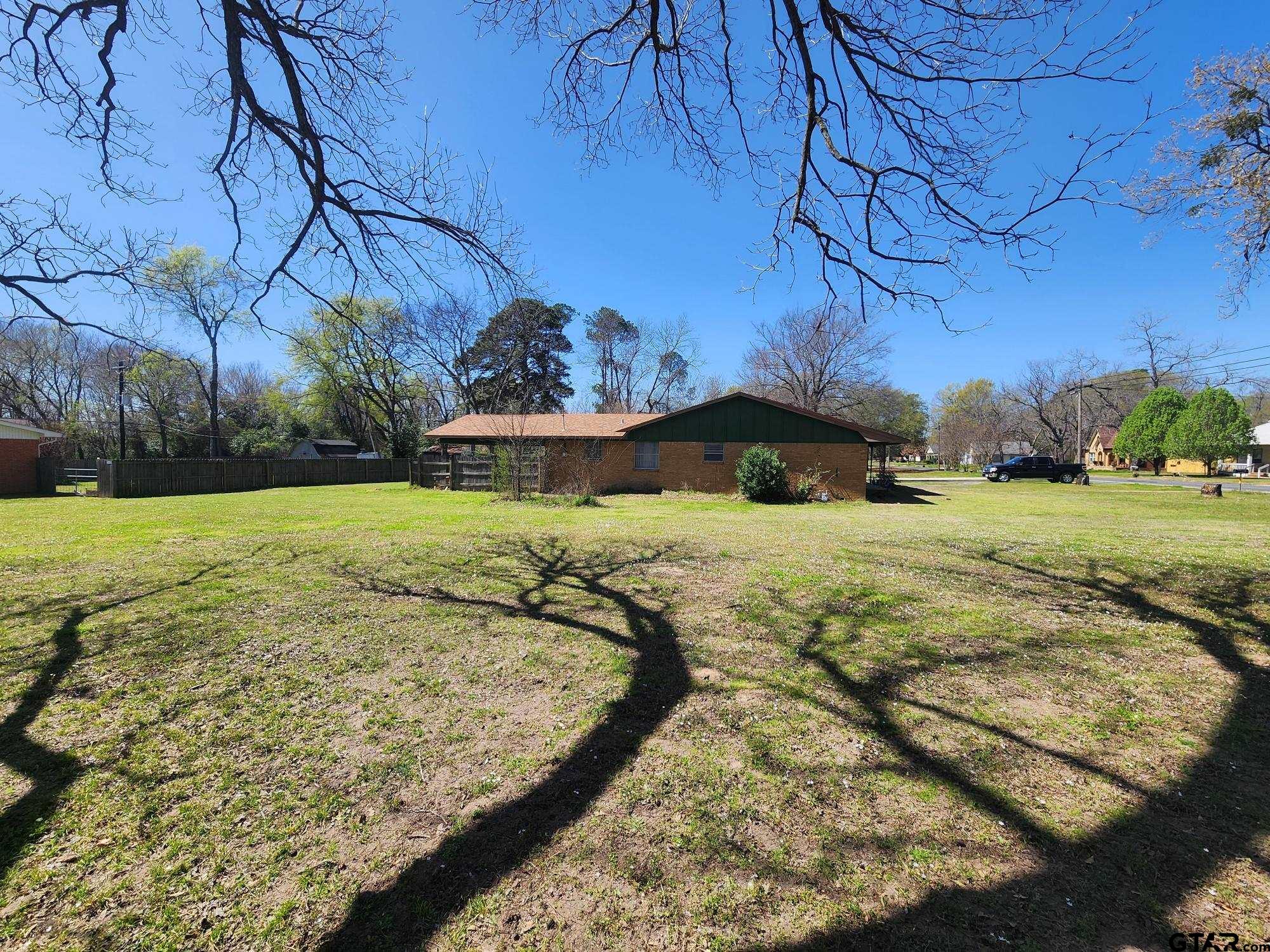 512 E Lane Quitman, TX 75783 - Photo 4 of 32 a view of a yard with an outdoor space