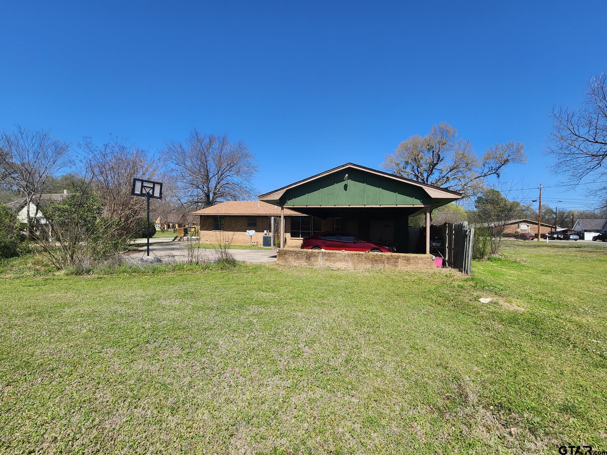 512 E Lane Quitman, TX 75783 - Photo 5 of 32 a front view of a house with garden