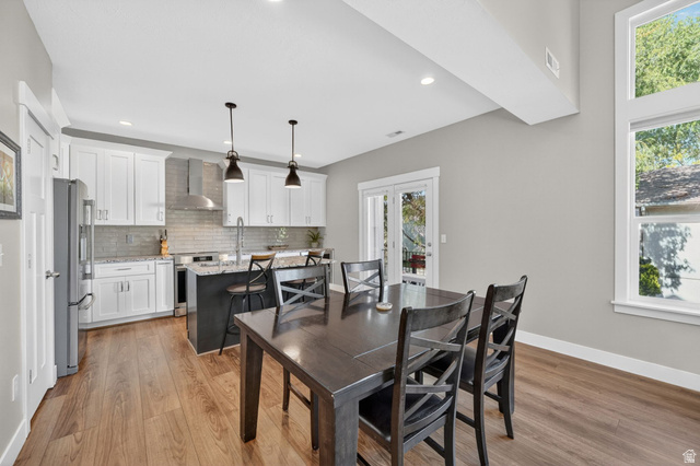 7872 Farm House Lane Midvale, UT 84047 - Photo 9 of 39 Open-concept space featuring wood-finish flooring and a bright kitchen
