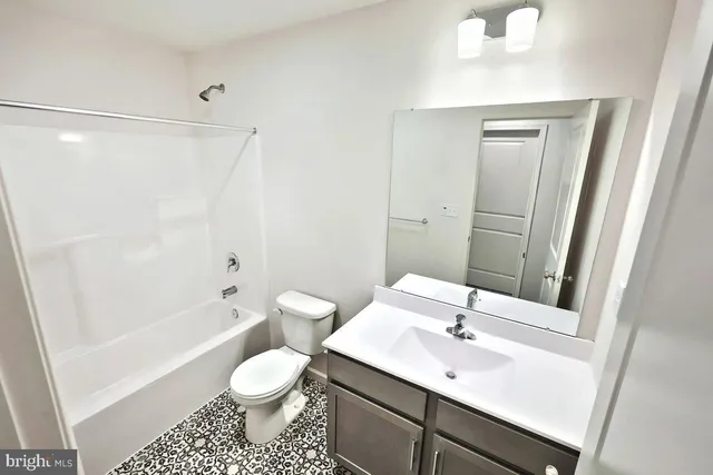 a bathroom with a sink vanity and a mirror