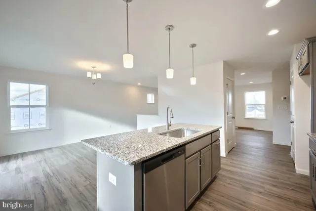 a kitchen with sink and mirror