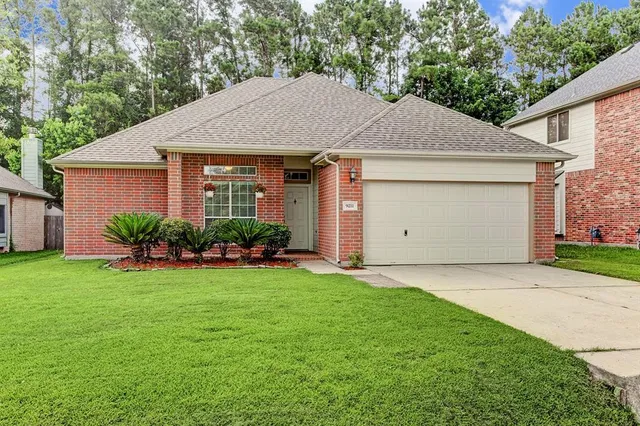 a front view of a house with a garden and yard