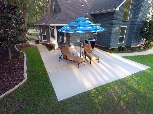 an aerial view of a house with garden space and lake view