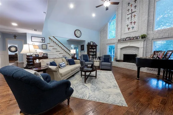 a living room with furniture a fireplace and kitchen view