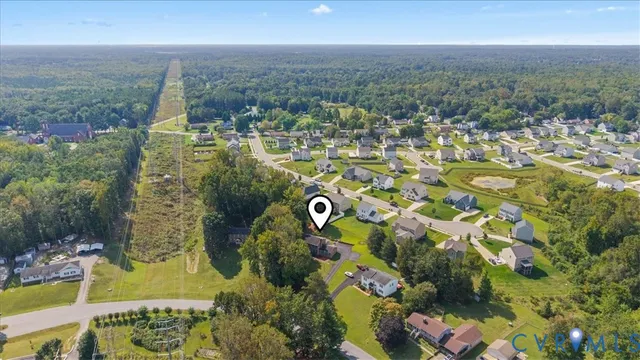an aerial view of residential houses with outdoor space and street view