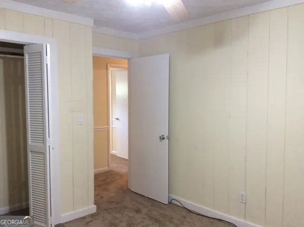 a view of hallway with closet area