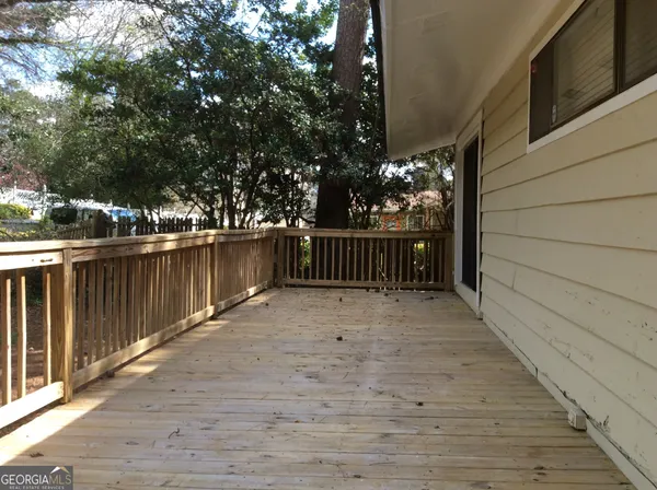 a view of a yard with wooden fence