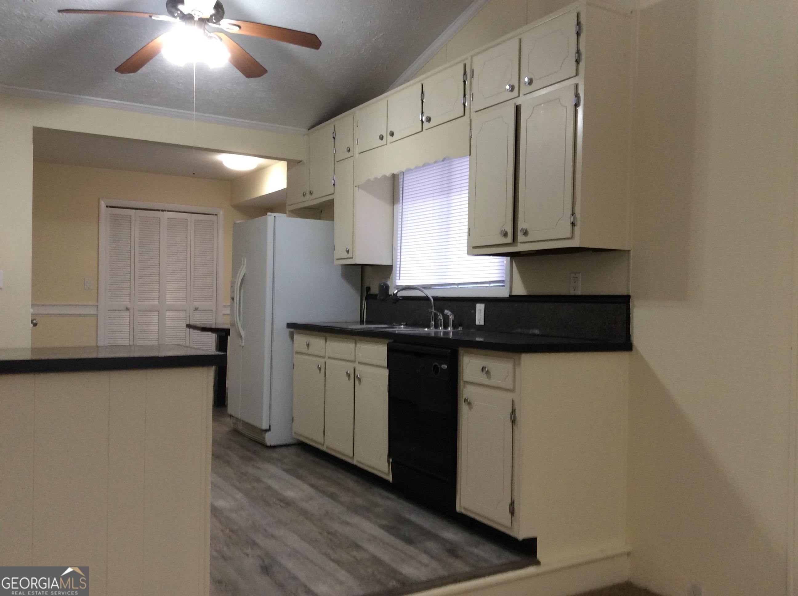 5022 Rock Springs Road Lithonia, GA 30038 - Photo 7 of 35 a kitchen with granite countertop white cabinets and a sink