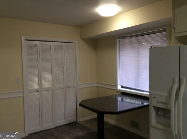a view of a refrigerator a sink a counter space and cabinets