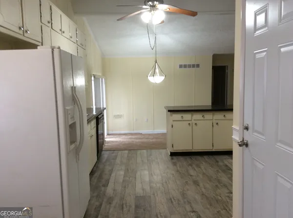 a kitchen with granite countertop a sink and cabinets