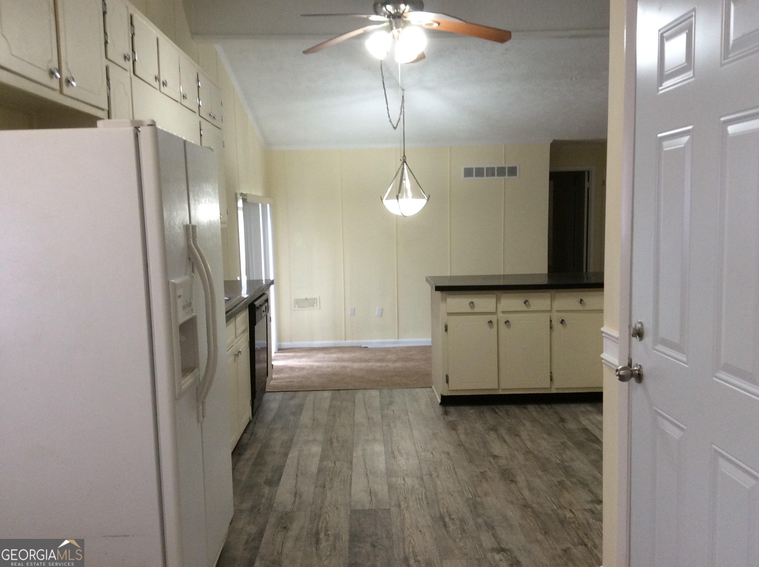 5022 Rock Springs Road Lithonia, GA 30038 - Photo 9 of 35 a view of a refrigerator a sink a counter space and cabinets