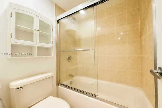 a bathroom with a shower and toilet