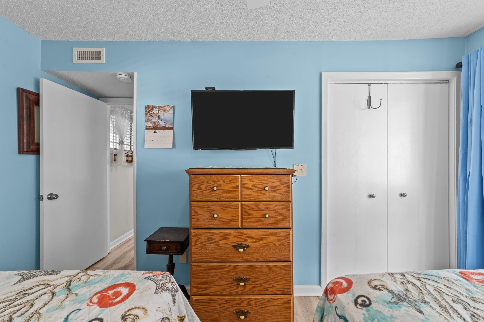 351 Lake Arrowhead Road, Unit 211 Myrtle Beach, SC 29572 - Photo 11 of 40 Bedroom with a closet, a textured ceiling, and light wood-type flooring