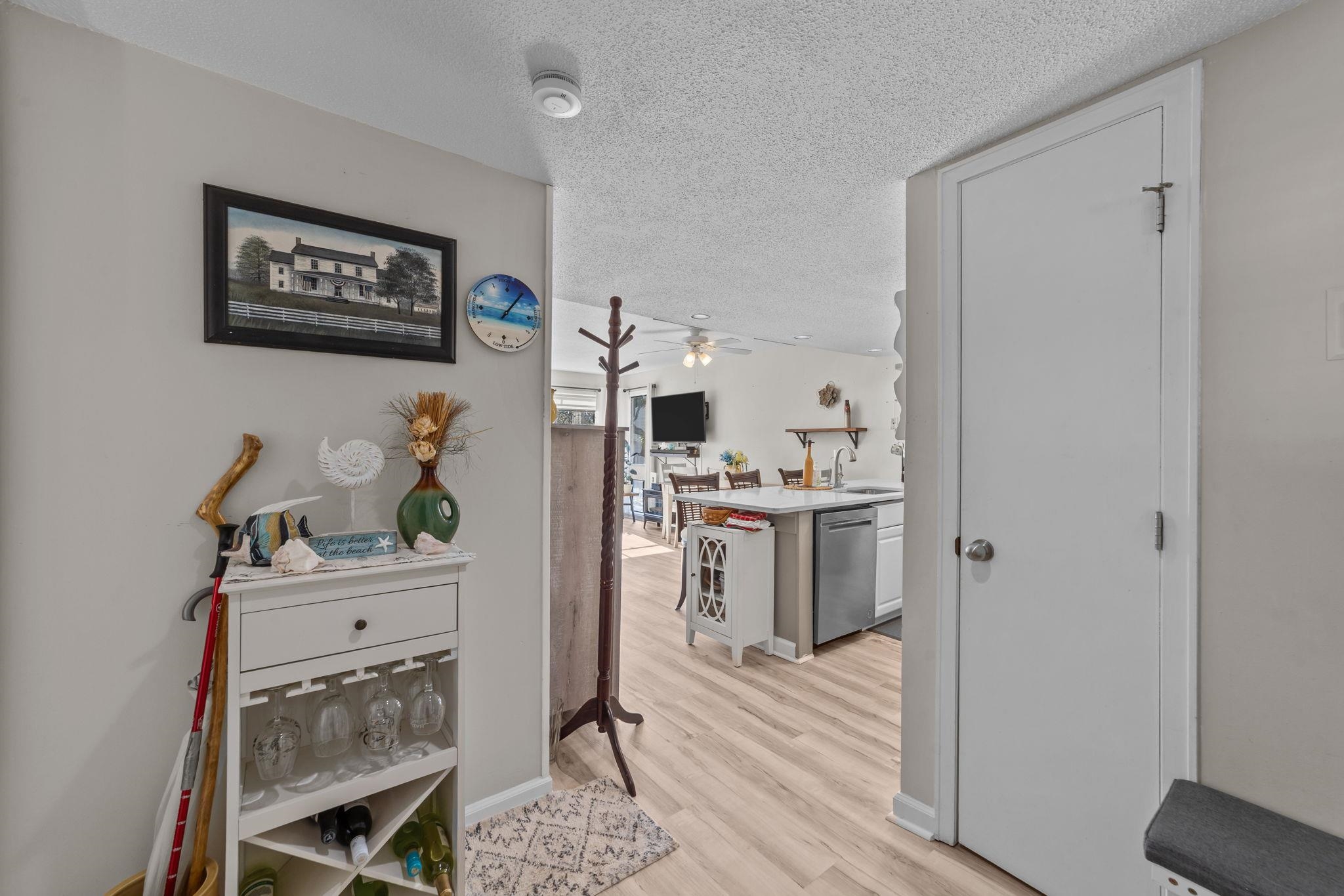 351 Lake Arrowhead Road, Unit 211 Myrtle Beach, SC 29572 - Photo 4 of 40 Hallway with a textured ceiling and light wood-style floors