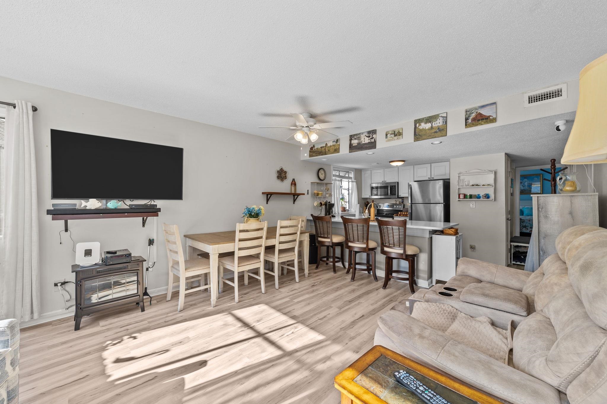 351 Lake Arrowhead Road, Unit 211 Myrtle Beach, SC 29572 - Photo 7 of 40 Living room featuring a ceiling fan and light wood-style floors