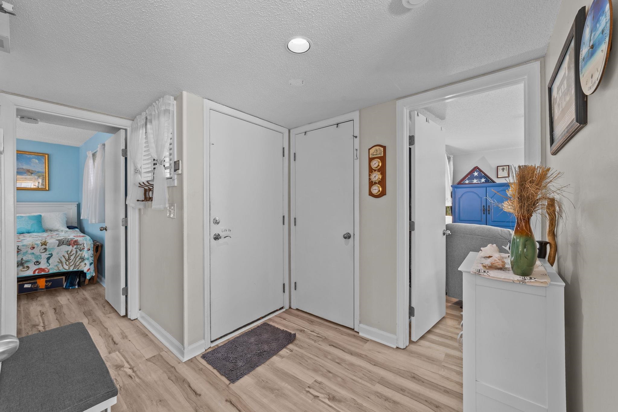 351 Lake Arrowhead Road, Unit 211 Myrtle Beach, SC 29572 - Photo 9 of 40 Foyer featuring a textured ceiling and light wood finished floors