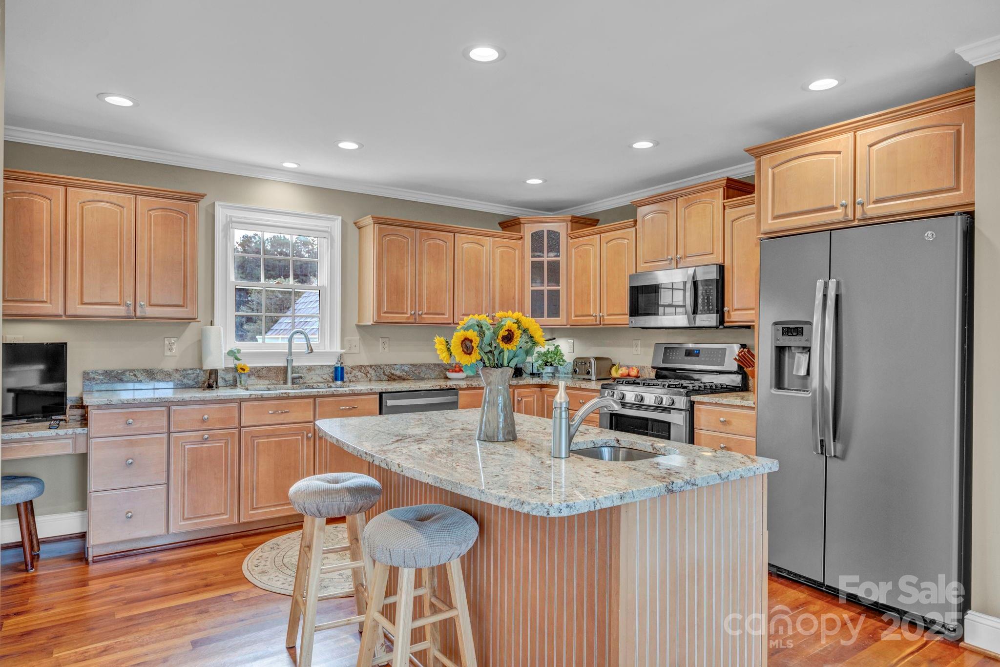 400 Ratledge Road Mocksville, NC 27028 - Photo 11 of 48 a kitchen with granite countertop kitchen island cabinets stainless steel appliances and wooden floor