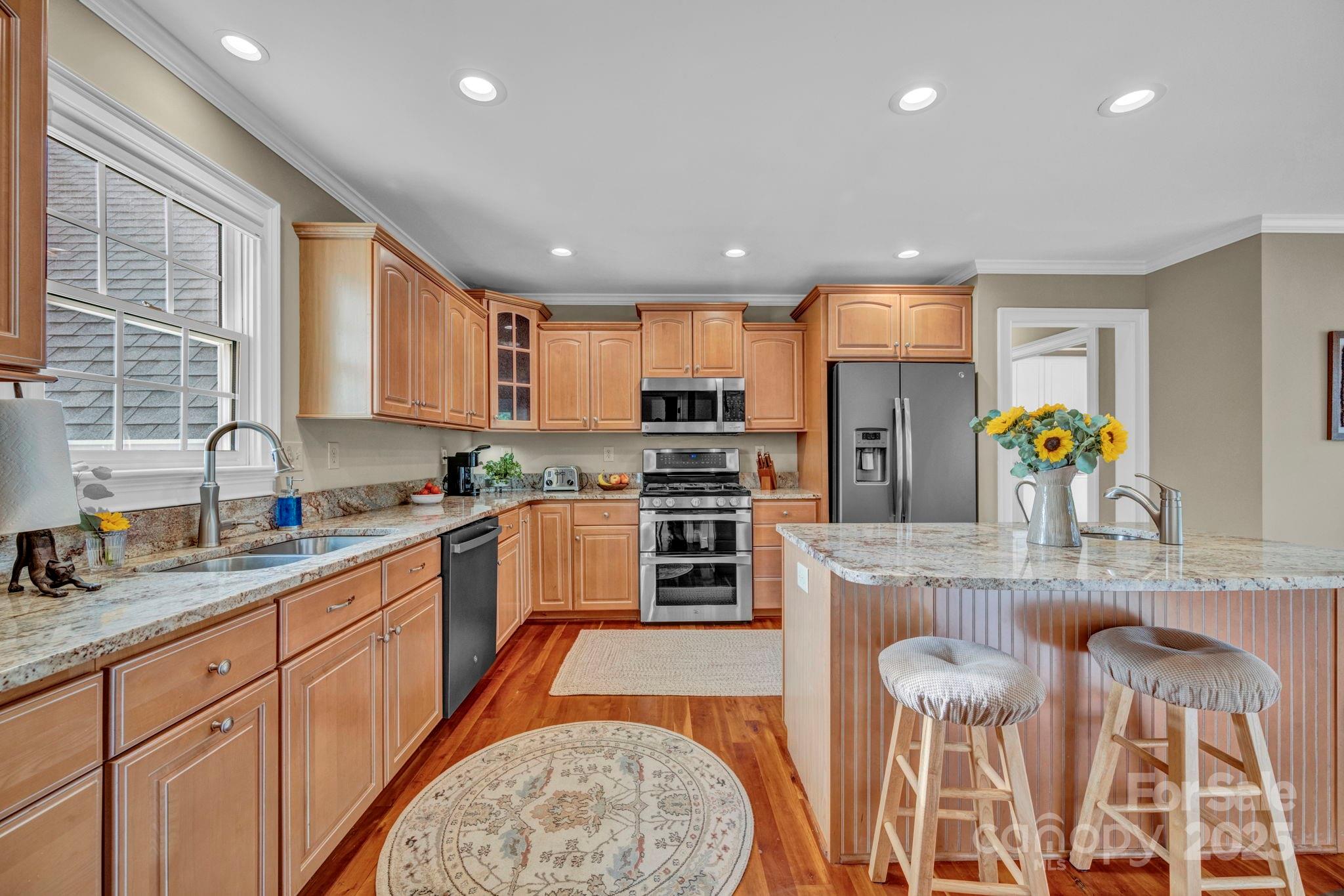 400 Ratledge Road Mocksville, NC 27028 - Photo 12 of 48 a kitchen with stainless steel appliances granite countertop a sink and cabinets