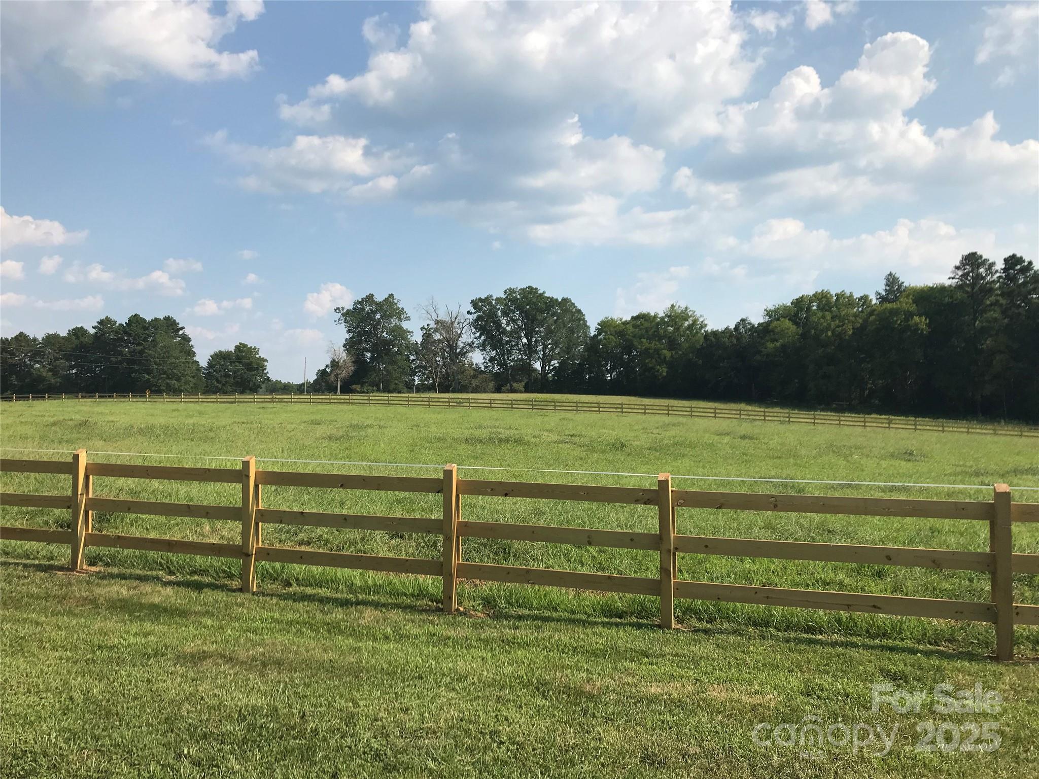400 Ratledge Road Mocksville, NC 27028 - Photo 41 of 48 a view of a green field with wooden fence