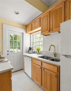 a kitchen with stainless steel appliances granite countertop a sink a stove and cabinets