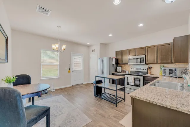 a kitchen with sink refrigerator and microwave