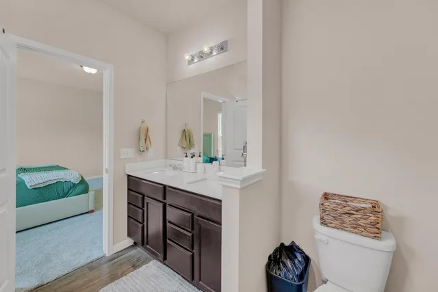 a bathroom with a sink a toilet and a mirror